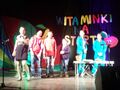 Sześcioro harcerzy w kolorowych strojach występuje na scenie w kinie i śpiewa piosenkę o witaminkach
