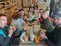 Grupa uczniów z opiekunami jedzą posiłek w McDonalds