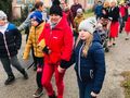 Uczniowie wraz z nauczycielami idą w pochodzie przez miejscowość Konarzew