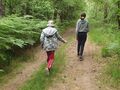 dwóch wychowanków maszeruje drogą leśną