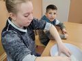 2. Dziewczynka miesza składniki potrzebne do wykonania sztucznego śniegu