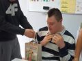 Kolega wręcza urodzinowy prezent jubilatowi