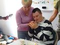 Uczeń z wychowawczynią patrzą na tort ze świeczkami