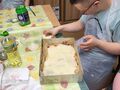 6.Bartosz układa plasterki sera żółtego na cieście