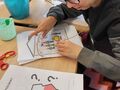9. Oliwia sumiennie wypelnia ksiazeczkę strona po stronie