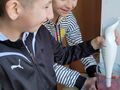 4. Chłopiec blenduje truskawki dziewczynka trzyma pojemnik 