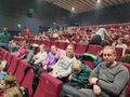 Zdjecie 3 Wszyscy uczniowie i opiekunowie czekają na spektakl siedzą w sali kinowej