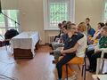 4.Uczniowie i nauczyciele siedzą i słuchają o. Walentego