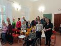 6.uczniowie i nauczyciele stoją i śpiewają w sali