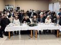 9.konkurs kolęd jury siedzi przy stole w tle uczestnicy