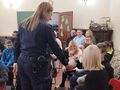 Pani policjantka częstuje dzieci cukierkami