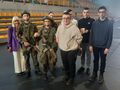 uczniowie i pani dyrektor stoją razem z uczniami ubranymi w mundury