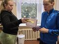 4. Dziewczynka wręcza koledze upominki z okazji Dnia Chłopaka 