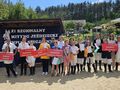 zdjęcie grupowe wszystkich zawodników z tabliczkami klubów w tle napis XI regionalny mityng jeżdziecki olimpiad specjalnych